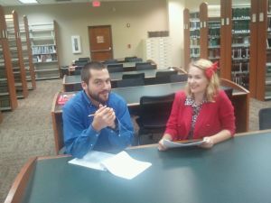 Trammell/Ahlers/Studwell Law Library Fellow Jonathan Germann and Technical Services & Mail Assistant Brittany O'Neill try out the new library chairs